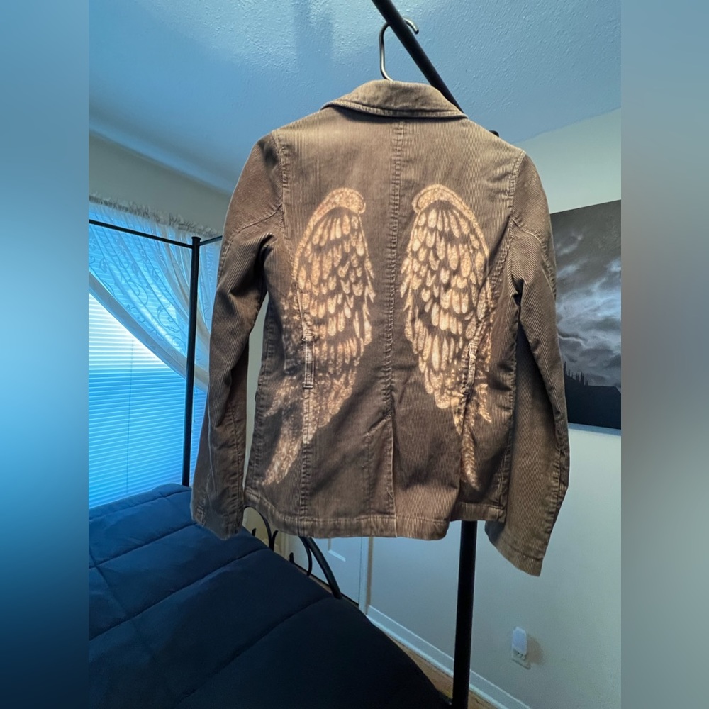 Custom jacket with star and wings detail.